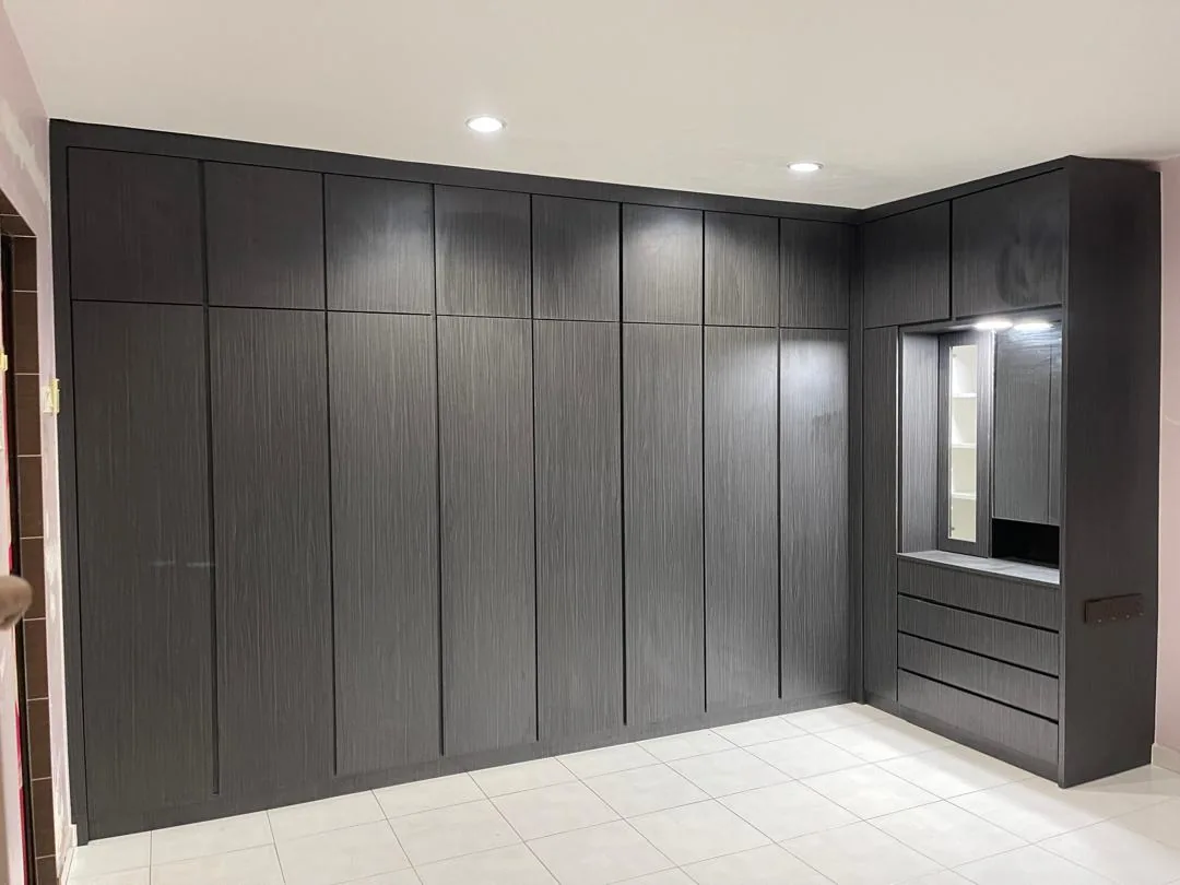 Floor-to-ceiling custom wardrobe and dressing unit in dark wood finish
