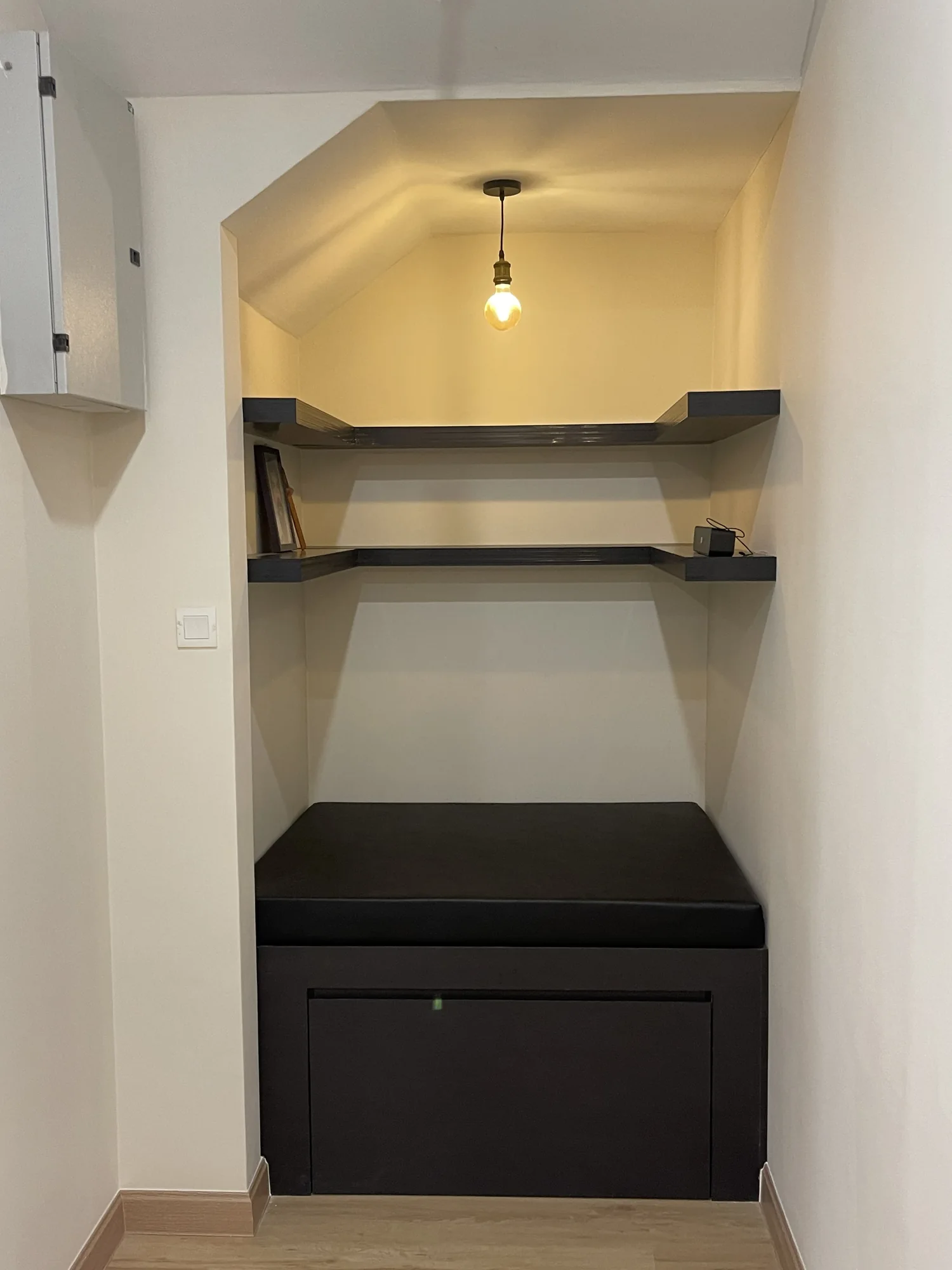 Compact custom study nook with desk surface and floating shelves