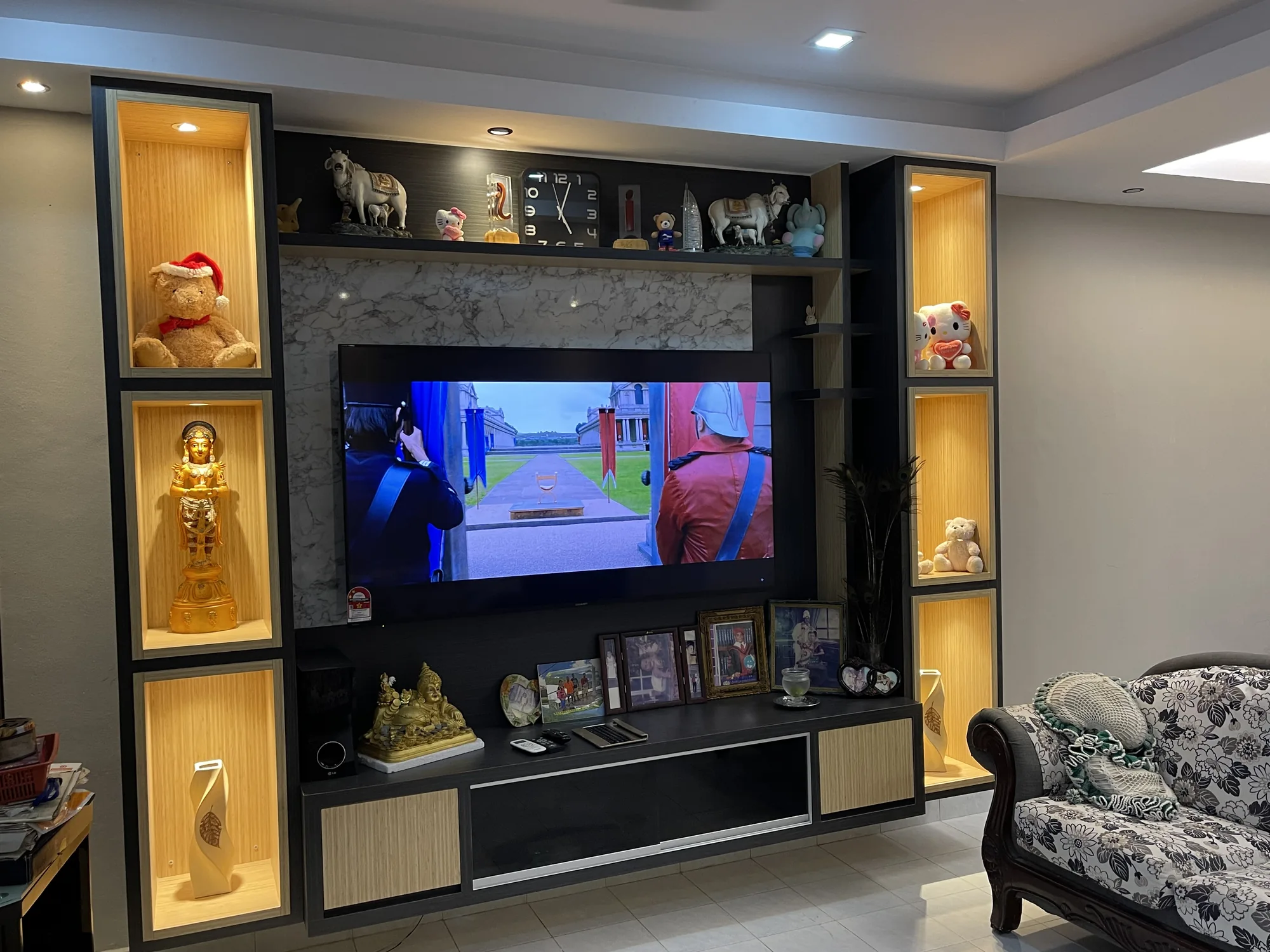 Custom TV console with warm illuminated display cabinets