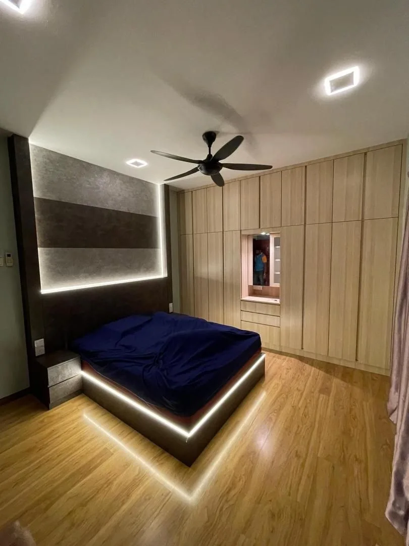 Modern custom bed frame with integrated bedside surfaces, wall panelling and warm concealed lighting