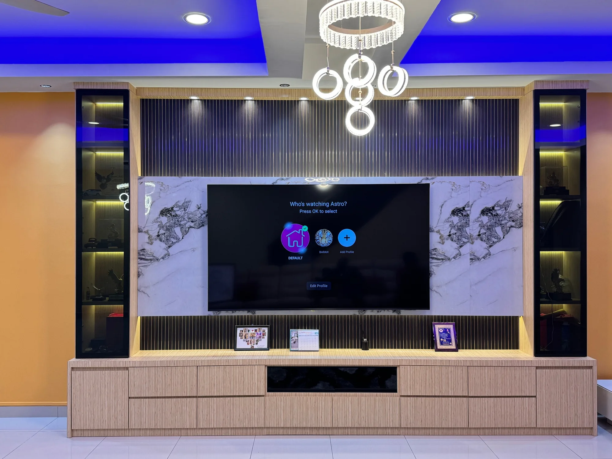 Completed feature wall with illuminated display cabinetry and TV console
